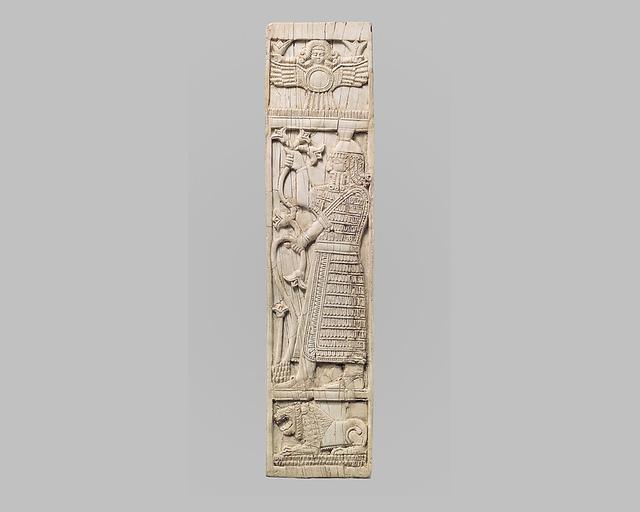 Furniture plaque carved in relief with warrior holding lotuses