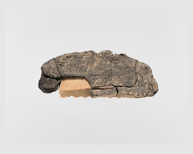 Sickle blade set in bitumen for attachment to a handle